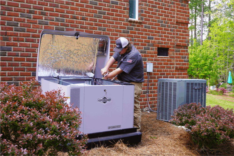 Technician servicing a generator outside a brick home.